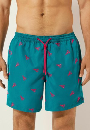 Pantaloncini da bagno turchesi con motivi di aragosta rossi, dotati di una vita elastica e cordino regolabile, texture liscia.