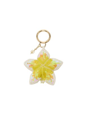 Gold keyring attached to a yellow and white star-shaped sequin and bead ornament.