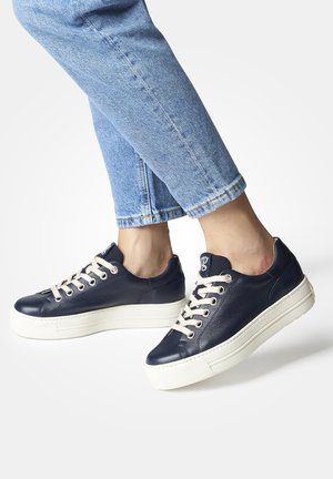 Navy leather sneakers with cream laces, white rubber soles, rounded toe, and a textured finish.  Casual design with side logo detail.