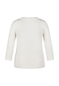 Long-sleeve, crew-neck top in light cream, made of smooth cotton. Features a simple design with minimal seams and a relaxed fit.