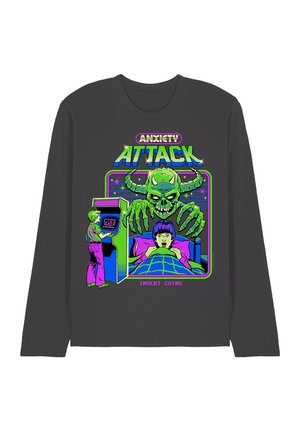 Green horned demon reaching over frightened person in bed, person playing arcade game, text "Anxiety Attack" and "Insert Coins" on dark shirt.