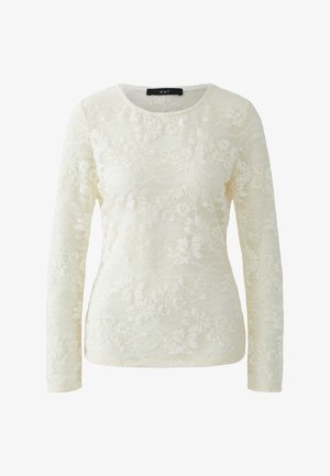 Langärmeliges Oberteil aus cremefarbener Spitze mit Blumenmustern, einem runden Ausschnitt und einer strukturierten Oberfläche mit subtiler Transparenz.