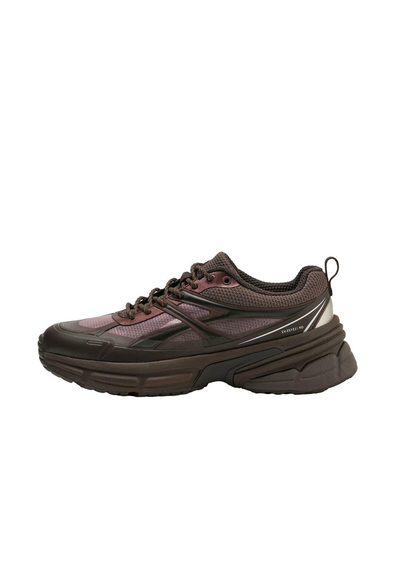 Chunky athletic shoe in dark brown and purple with mesh upper, sturdy sole, and contrasting silver accents; features lace-up design and padded collar.