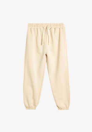 Beige sweatsuitit, jossa on joustava vyötärö, nyöri ja kapenevat hihansuut. Valmistettu pehmeästä kankaasta, jossa on sileä pinta ja yksinkertainen muotoilu.