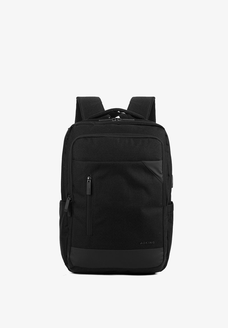 Zaino in tessuto nero con spallacci imbottiti, multiple tasche con zip e un design elegante. Presenta dettagli texture e superfici lisce.