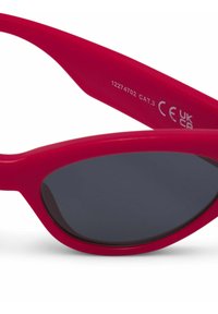 Red plastic sunglasses with cat-eye shape and dark gray lenses, featuring a smooth finish and model details on the inner arm.