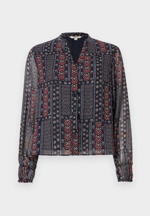 Průsvitná námořnicky modrá halenka s dlouhými rukávy, zapínáním na knoflíky a květinovým a listovým vzorem v červené, bílé a modré barvě.