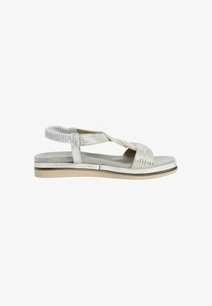 Silver sandal with a textured strap design, adjustable ankle support, and a thick, light-colored sole. Smooth suede-like footbed texture.