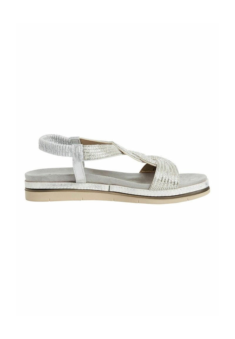 Silver sandal with a textured strap design, adjustable ankle support, and a thick, light-colored sole. Smooth suede-like footbed texture.