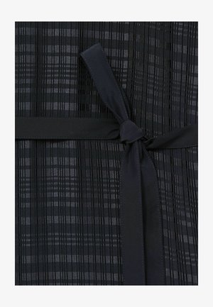 Black dress featuring vertical pleats, a smooth fabric texture, and a matching tie belt at the waist. Subtle alternating glossy stripes.