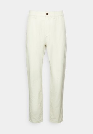 Lichtbeige broeken van een katoenmix, met een rechte snit, ritssluiting, enkele knoopsluiting en zijzakken. Soepele textuur.