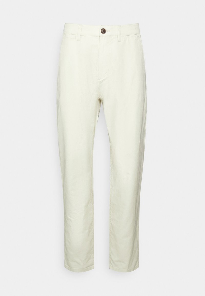 Světlé béžové kalhoty vyrobené z bavlněné směsi, s přímým střihem, zipem, jedním knoflíkem a předními kapsami. Hladká textura.