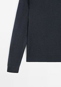 Maglione lavorato a maglia di un blu navy scuro, caratterizzato da un colletto rotondo e maniche lunghe, con una consistenza liscia e polsini e orlo a costine.