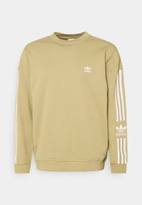 Grön sweatshirt med vitt Adidas-logotyp på bröstet och tre vita ränder längs varje ärm. Mjukt tyg och design med rundad hals.