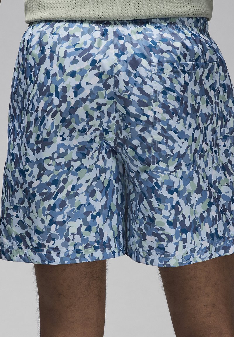 Shorts de bain à motifs bleus et verts en tissu léger, dotés d'une taille élastique et d'une poche arrière.