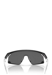 Occhiali da sole neri oversize con lenti curve, aste trasparenti chiare e forma geometrica, caratterizzati da un design minimalista.