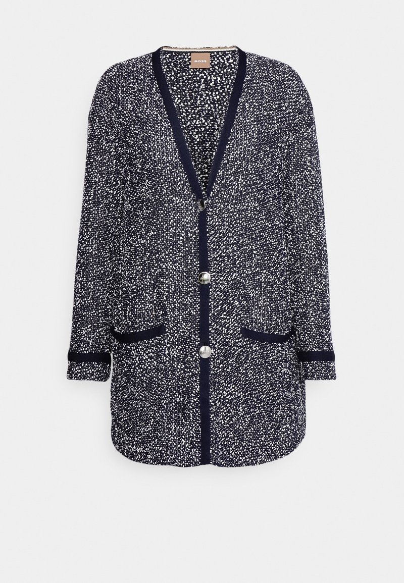 Cardigan à manches longues bleu marine avec motif moucheté blanc, trois boutons argentés, deux poches avant et bordures unies bleu marine aux poignets et aux bords.