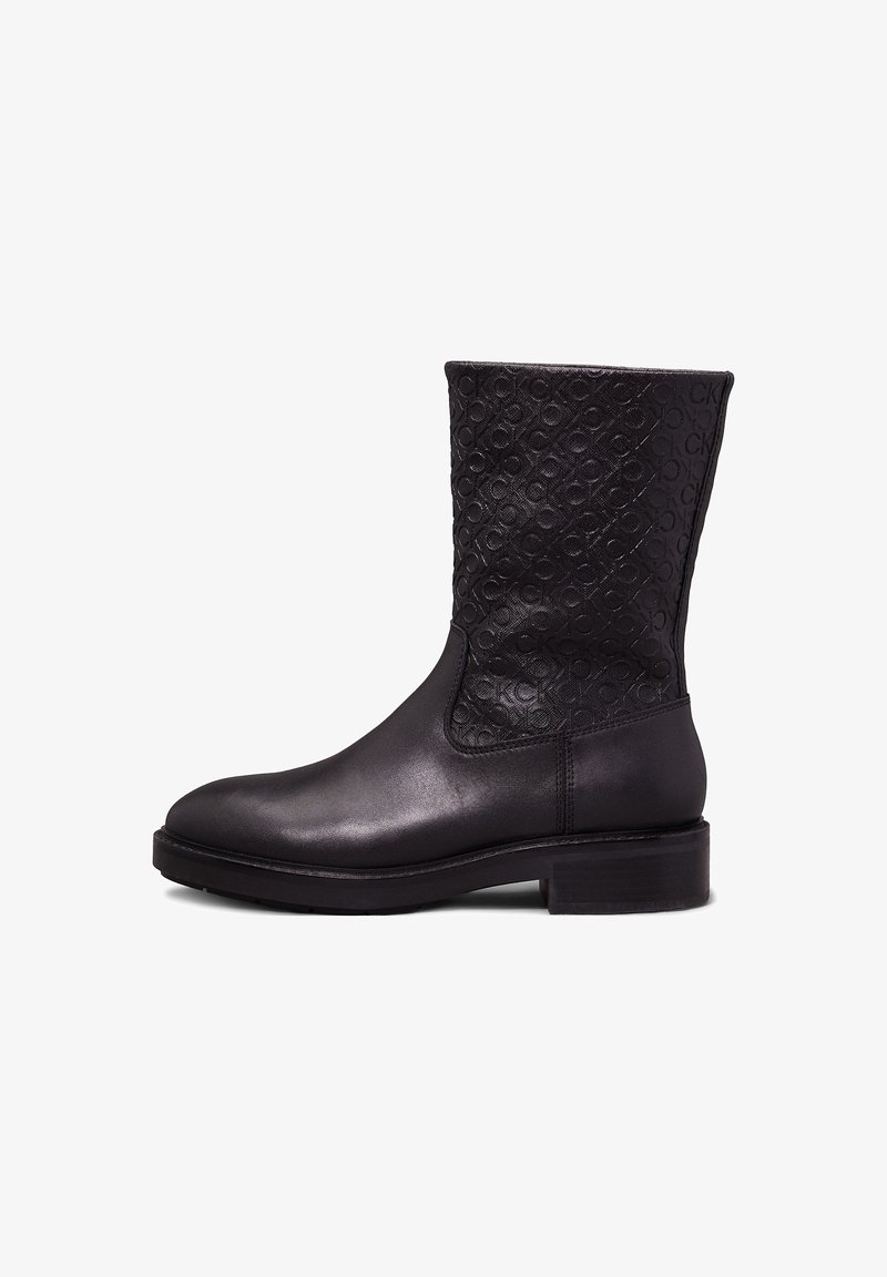Black leather ankle boot with a textured shaft featuring an embossed logo pattern. Round toe and block heel, smooth finish on the body.