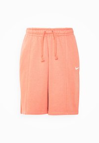 Coral Nike shorts, made from soft fabric, featuring an elastic waistband with adjustable drawstring and embroidered logo on the side.