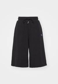 Schwarze Jerseykurzschlüsse mit elastischem Bund und Kordelzug. Mit einem Logo an der Seite und einem lockeren, weiten Schnitt. Weicher Stoff.