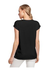 Schwarz, kurzärmliges T-Shirt mit Rundhalsausschnitt. Glattes, leichtes Material und aufgeschlagene Ärmel, von hinten betrachtet.