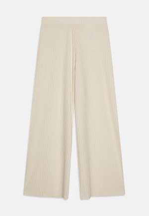 Pantalons évasés de couleur beige clair avec une texture en côtes verticales. Ils disposent d'une taille confortable et d'un tissu fluide pour faciliter les mouvements.