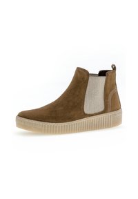 Bottines Chelsea en suède marron avec un panneau élastique texturé, semelle en caoutchouc et une languette à l'arrière. Présente un motif à chevrons rayé.