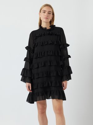 Black dress made of lightweight fabric, featuring multiple horizontal ruffles, long sleeves, and a frilled neckline. Simple and elegant design.