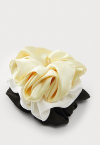 Satin scrunchie set with three colors: yellow, white, and black. Features a soft, smooth texture with gathered fabric design.