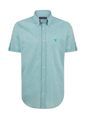 Camisa de botón de manga corta en tejido texturizado azul claro. Cuenta con un collar y un logo bordado de un pájaro en el pecho. Corte ajustado.