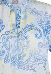 Lightweight, semi-sheer blouse featuring a blue paisley print on a pastel background. Yellow accents along the neckline. Short sleeves.