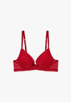 Soutien-gorge en dentelle rouge avec bretelles ajustables, bords festonnés, bonnets rembourrés et un détail de nœud central. Présente un motif floral en dentelle.