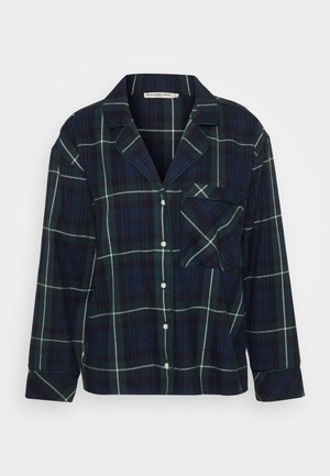 Ναυτικό καρό φλις πιτζάμα με πράσινες και λευκές ρίγες, κουμπί για κλείσιμο, κολάρο με αυλάκι και μία τσέπη στο στήθος. Μαλακή υφή.