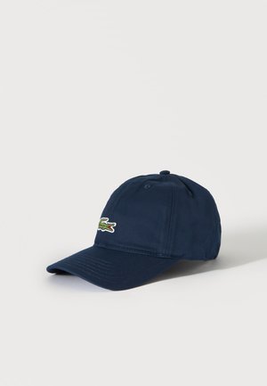 Marineblauwe honkbalpet met een gebogen klep en een groen krokodillenlogo geborduurd aan de voorlinkerkant.