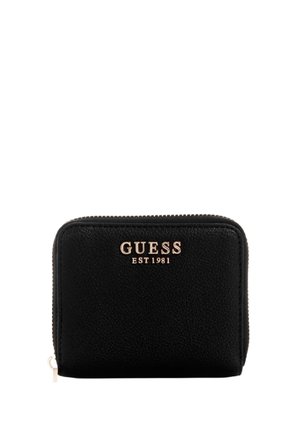 Black leather wallet with textured surface. Features a gold "GUESS EST 1981" logo on the front and a zip closure. Compact rectangular shape.