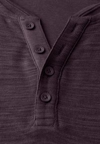 Dark purple henley shirt featuring a textured fabric, five buttons, and a V-neck. The design includes a subtle ribbed pattern and contrasting button color.