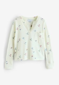 Lysegul strikket pullover med en blød tekstur, med V-udskæring, lange ærmer og en forlommer, dekoreret med farverige skisportsmønstre.