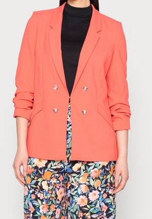 Blazer corallo doppiopetto realizzato in tessuto morbido, caratterizzato da un design raffinato, rever a punta e bottoni metallici lucidi abbinati a pantaloni con fantasia floreale.