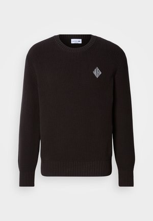 Maglione nero a coste con scollo rotondo e maniche lunghe. Presenta un piccolo logo a forma di diamante sul petto. Realizzato in materiale lavorato a maglia testurizzato.