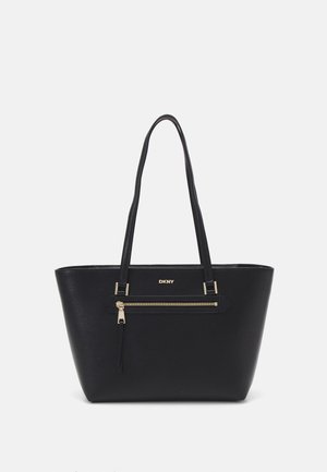 Black leather tote bag with a textured finish, two long handles, and a front zipped pocket. Gold-tone hardware adds contrast.