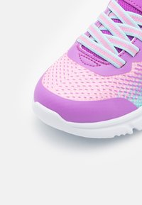 Chaussure de sport violette avec une tige en mesh texturé, des lacets bleu clair contrastants et une semelle blanche avec un design de crans.