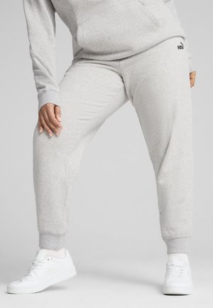 Lys grå sweatpants med elastiske manchetter, sidelommer og et lille sort logo. Kombineret med hvide sneakers. Blødt, struktureret stof.