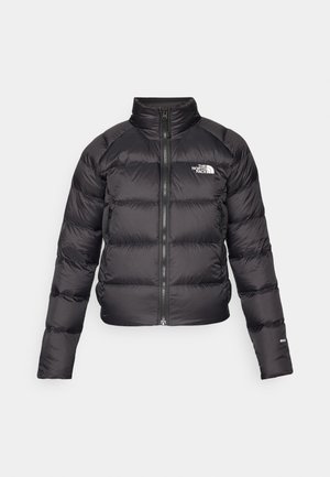 Black puffer jacket with a high collar, zip closure, and side pockets. Features quilted sections and a logo on the chest. Lightweight, insulated.