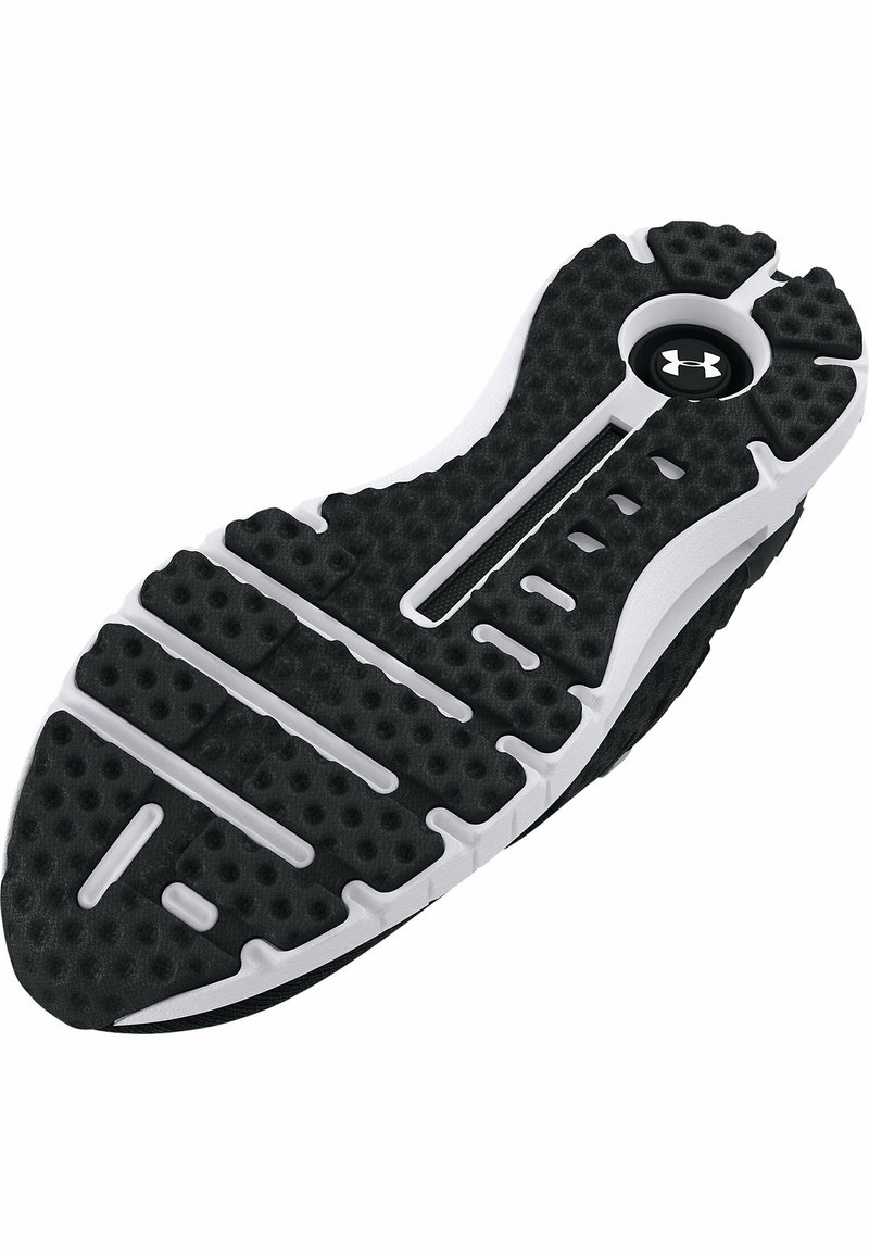 Suela de zapato deportivo en blanco y negro con superficie texturizada, ranuras y un logo circular. Presenta burbujas de amortiguación y un diseño resistente.