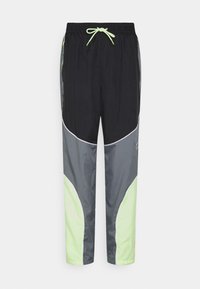 Schwarze und graue Jogginghose mit einem Kordelzugbund, seitlichen Akzenten in hellgrün und einem geschwungenen Farbblockierungsdesign.