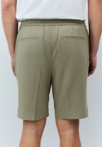 Khaki shorts with an elastic waistband, two back pockets, and a tailored design, featuring a smooth, lightweight fabric and knee-length cut.