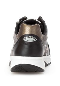 Black and metallic gold sneaker with textured upper, padded collar, white sole, and contrasting white stripe. Features "rollingsoft" logo.