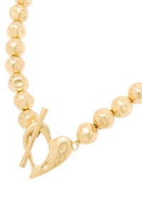 Naszyjnik w kolorze złota z okrągłymi i nieregularnymi koralikami, z zapięciem typu toggle w kształcie serca. Gładkie wykończenie, polerowany wygląd i subtelna tekstura.