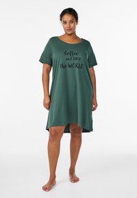 Green short-sleeve dress with a round neckline and loose fit, featuring black text "Coffee and then the WORLD" centered on the front.