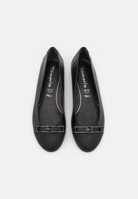Black leather ballet flats featuring a rounded toe, smooth texture, and a decorative black hardware accent across the front.